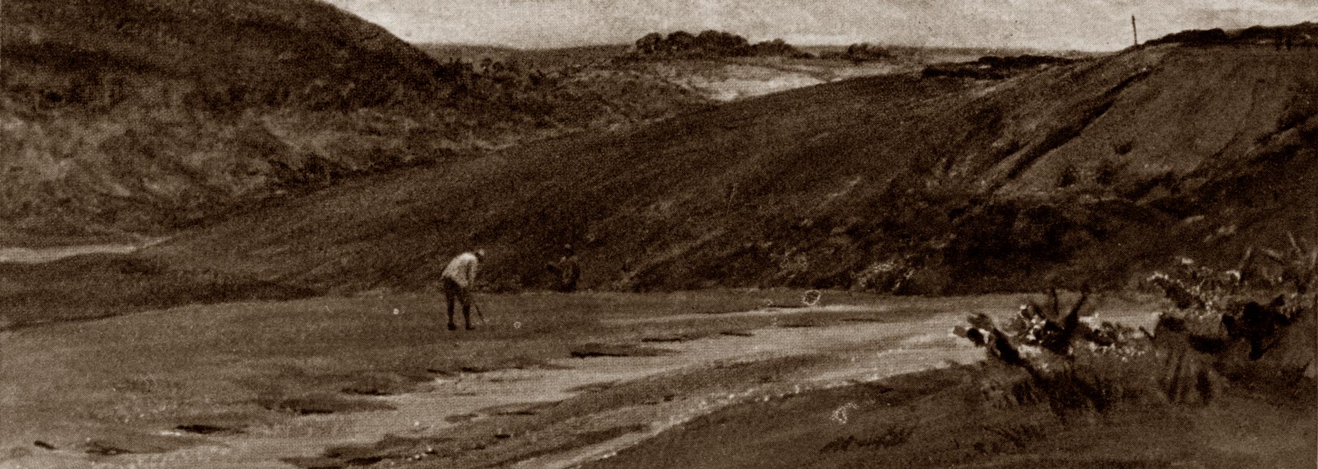 man in field playing golf